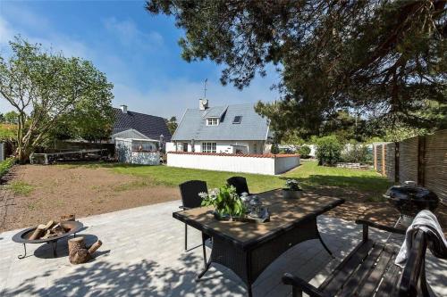 a patio with a table and chairs and a house at 1319-N-Liseleje-Liselejevej-55 in Liseleje