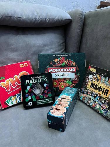 a group of games and books on a couch at Хостел Піонер in Sumy