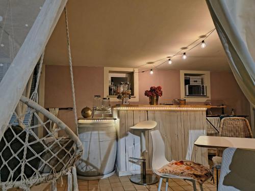 a kitchen with a bar and a table and chairs at B&B Tra colline marchigiane - sauna e piscina in San Giorgio di Pesaro