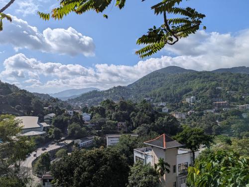 a view of a city with mountains in the background at Udawatta Kele (UK) Forest Lodge in Kandy