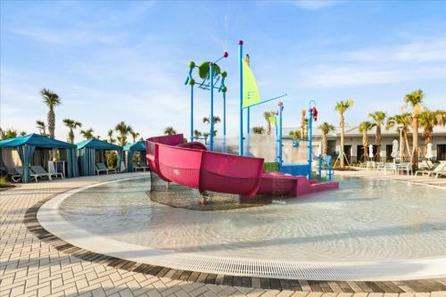 a water park with a slide in the water at 10 Bedrooms 8 Bathrooms Windsor Cay 16207Cc in Clermont
