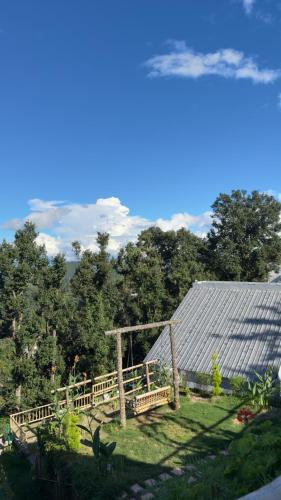 a view of a garden with a solar roof at Himadvaya- The Himalayan Prism in Almora