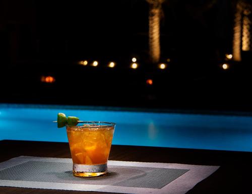 a drink with a lime on top of a table at Arabian Nights Resort & Spa in Shāhiq