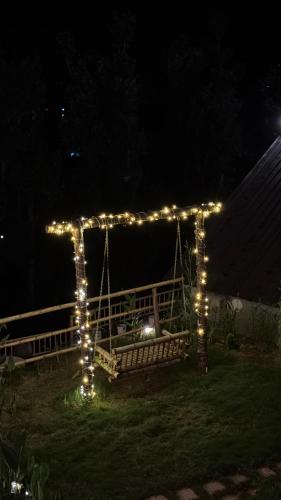 a gazebo with lights in a yard at night at Himadvaya- The Himalayan Prism in Almora