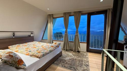 a bedroom with a bed and a large window at Himadvaya- The Himalayan Prism in Almora