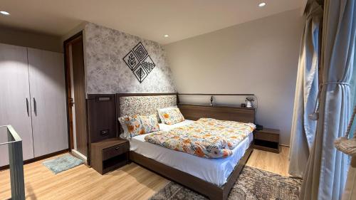 a small bedroom with a bed with a canopy at Himadvaya- The Himalayan Prism in Almora