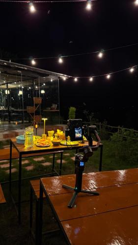 a table with a camera on top of it at night at Himadvaya- The Himalayan Prism in Almora