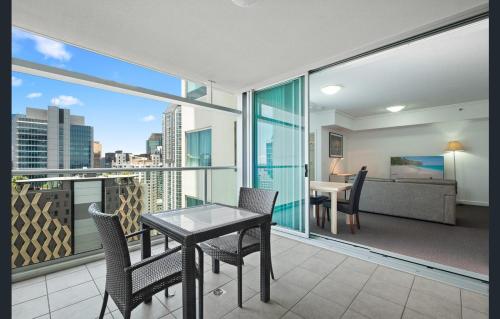 a balcony with a table and chairs and a couch at Location! Brisbane City Centre! Whole Apartment! in Brisbane