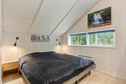 a bedroom with a bed and two windows at 946-Frederiksvaerk-Skelvaenget-3-a in Frederiksværk