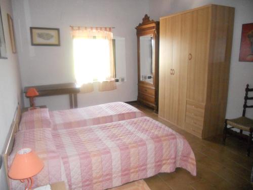 a bedroom with a bed and a window at Tenuta Il Tresto in Poggibonsi