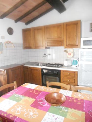 a kitchen with a table and a stove top oven at Tenuta Il Tresto in Poggibonsi