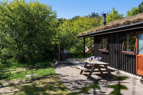 a picnic table in front of a cabin at BL245-Pandrup-Bremersvej-4 in Pandrup