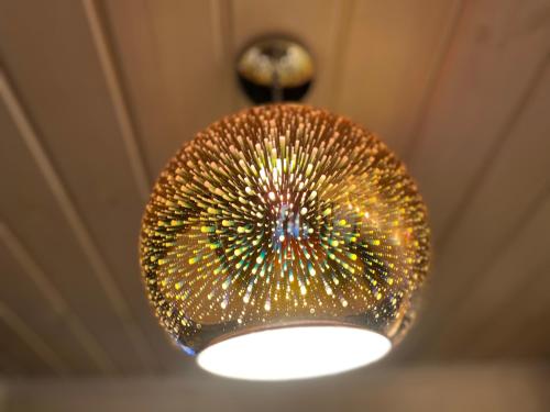 a chandelier hanging from the ceiling in a room at Silumetras in Ventspils
