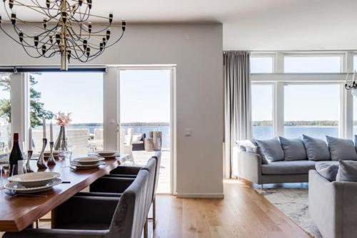 a living room with a table and a couch at Luxury villa in Kristinehamn