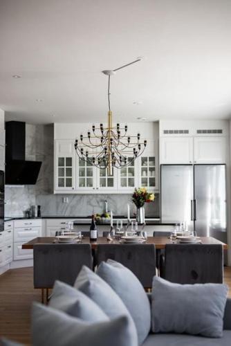 a kitchen with a chandelier and a table with chairs at Luxury villa in Kristinehamn