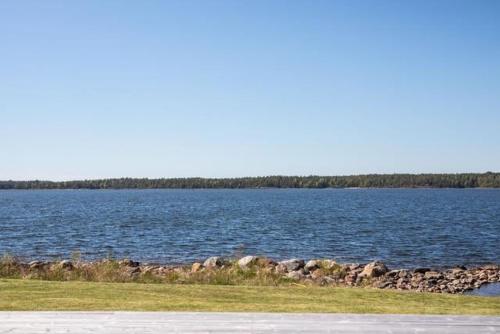 a large body of water with a rocky shoreline at Luxury villa in Kristinehamn