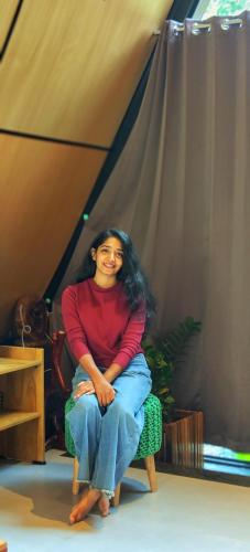 a woman sitting in a chair in a tent at Cherry Blossoms Chalet in Kozhikode
