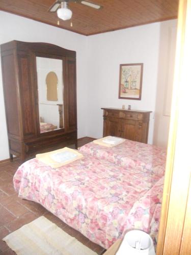 a bedroom with a bed with a dresser and a mirror at Tenuta Il Tresto in Poggibonsi