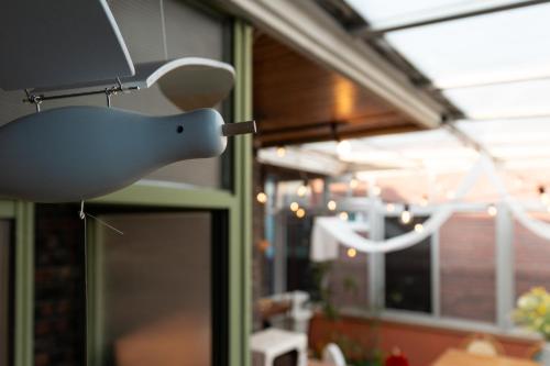a white bird light hanging from a wall at Chun cheon Bongstay 2nd Floor in Chuncheon