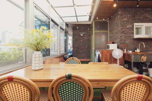 a dining room with a wooden table and chairs at Chun cheon Bongstay 2nd Floor in Chuncheon