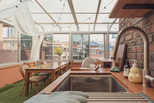 a kitchen with a large window and a table and chairs at Chun cheon Bongstay 2nd Floor in Chuncheon
