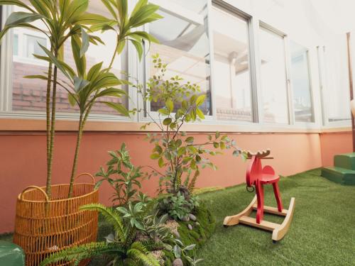 a room with palm trees and a toy on the grass at Chun cheon Bongstay 2nd Floor in Chuncheon