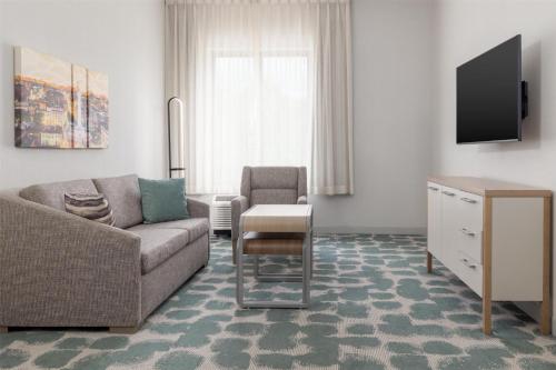 a living room with a couch and a chair at Homewood Suites by Hilton Baltimore - Arundel Mills in Hanover