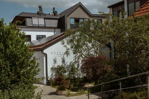 a white house with a roof on top of it at Mörwald Gutshof in Feuersbrunn