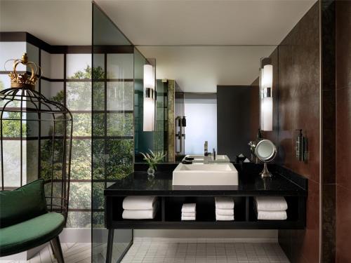 a bathroom with a sink and a mirror at The Starling Atlanta Midtown, Curio Collection by Hilton in Atlanta