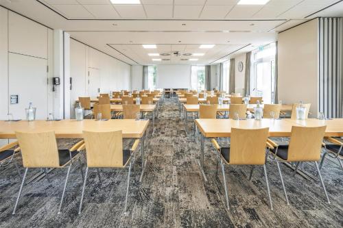 an empty room with tables and chairs in it at Best Western Plus Hotel Papenburg in Papenburg