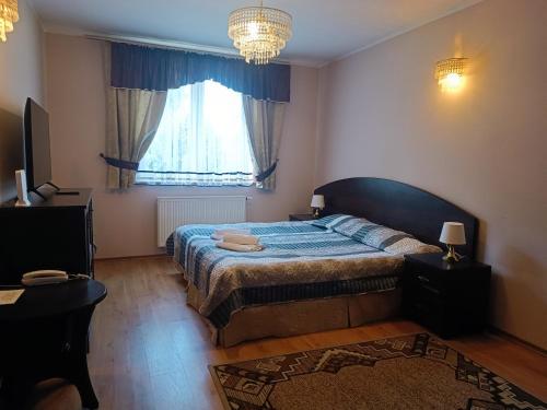 Ένα ή περισσότερα κρεβάτια σε δωμάτιο στο Hotel Willa Park