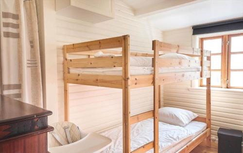 a bunk bed in a tiny house at 12228-Sjaellands-Odde-Strandvaenget-23 in Yderby