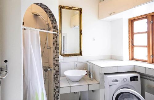 a bathroom with a sink and a washing machine at 12228-Sjaellands-Odde-Strandvaenget-23 in Yderby