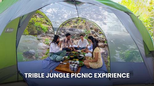 a group of people sitting around a table in a tent at Jungle Ghar in Pachmarhī