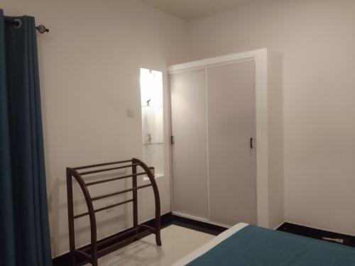 a bedroom with a bed and a closet and a door at Villa28 Habaraduwa in Habaraduwa