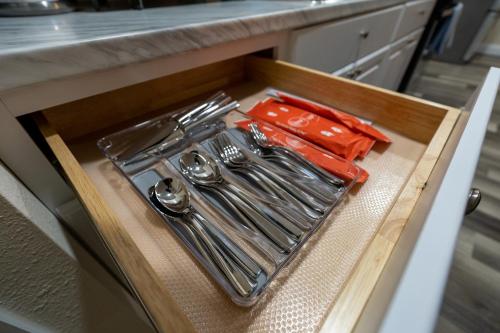 a tray of utensils in a drawer in a kitchen at GNV 4 Bed - Stay 4 mins to UF - Family and Alumni in Gainesville