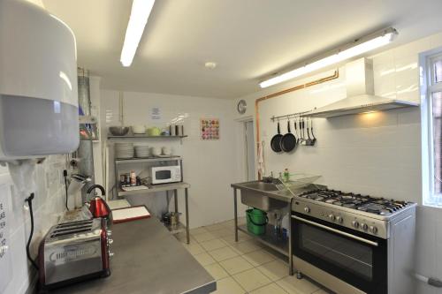 a kitchen with a stove top oven and a microwave at The Bunkroom in Chester