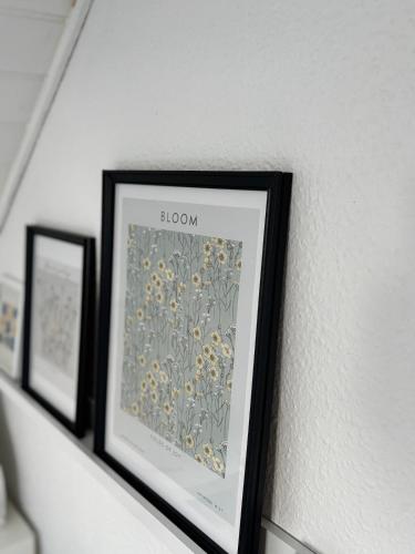 a framed picture of flowers on a shelf at Beautiful house with a charming garden in Brønderslev