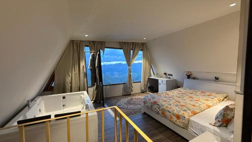 a bedroom with a bed and a large window at Himadvaya- The Himalayan Prism in Almora