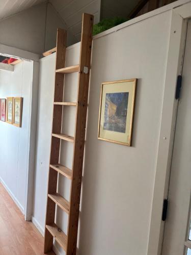 a ladder in a room next to a wall at Beautiful house with a charming garden in Brønderslev