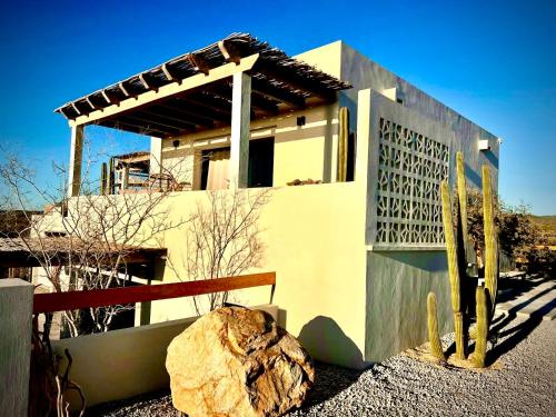 a house with a large rock in front of it at Casa del Mar - Luxury Seaside Villa in Boca de la Vinorama