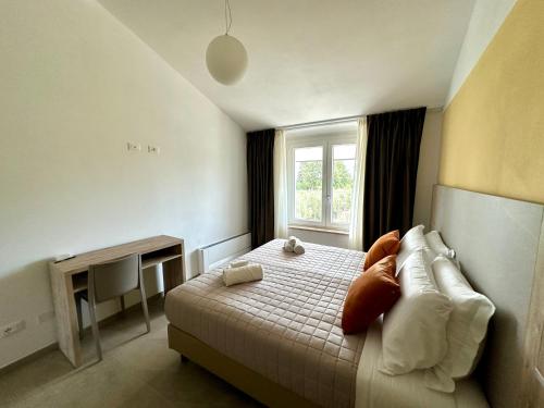 a bedroom with a bed with pillows and a window at AgriResort Il Casolare Rimini in Rimini