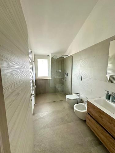 a bathroom with two sinks and two toilets at AgriResort Il Casolare Rimini in Rimini