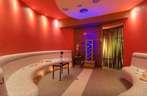a room with a large bath tub with a table at Hotel Federico II in Iesi