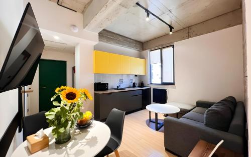 a living room with a couch and a table at Rooms Apart Hotel by RED in Yerevan