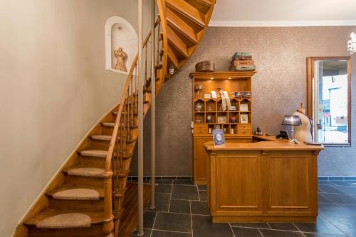 a kitchen with a spiral staircase in a house at Boutique Hotel Caelus VII in Tongeren