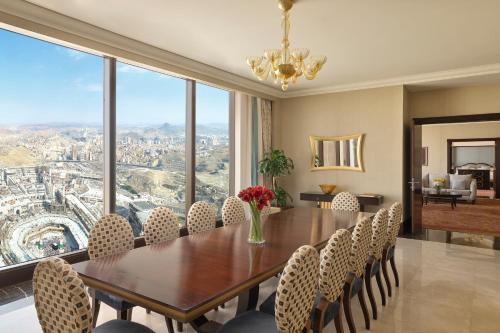 a dining room with a table and chairs with a view at Makkah Clock Royal Tower, A Fairmont Hotel in Makkah