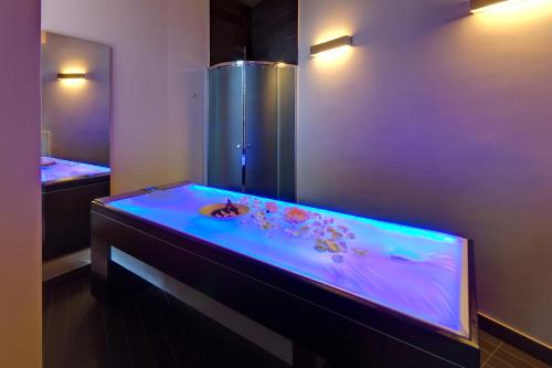 a bathroom with a tub with a sink in it at Hotel Federico II in Iesi