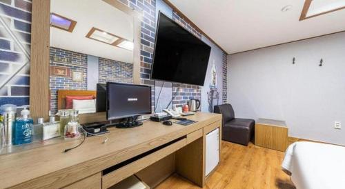 a room with a desk with a computer on it at Chuncheon World Hotel in Chuncheon