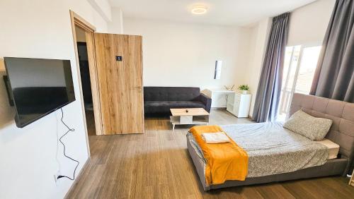 a living room with a bed and a couch at Downtown Rooms, 200m from Marina Beach in Larnaka